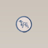 The Ballad of the Bird Dog Shop Patch is a circular embroidered Ballad Merit Badge featuring a blue outline and a standing Bird Dog image—ideal for dog lovers. Brand: Ballad of the Bird Dog.
