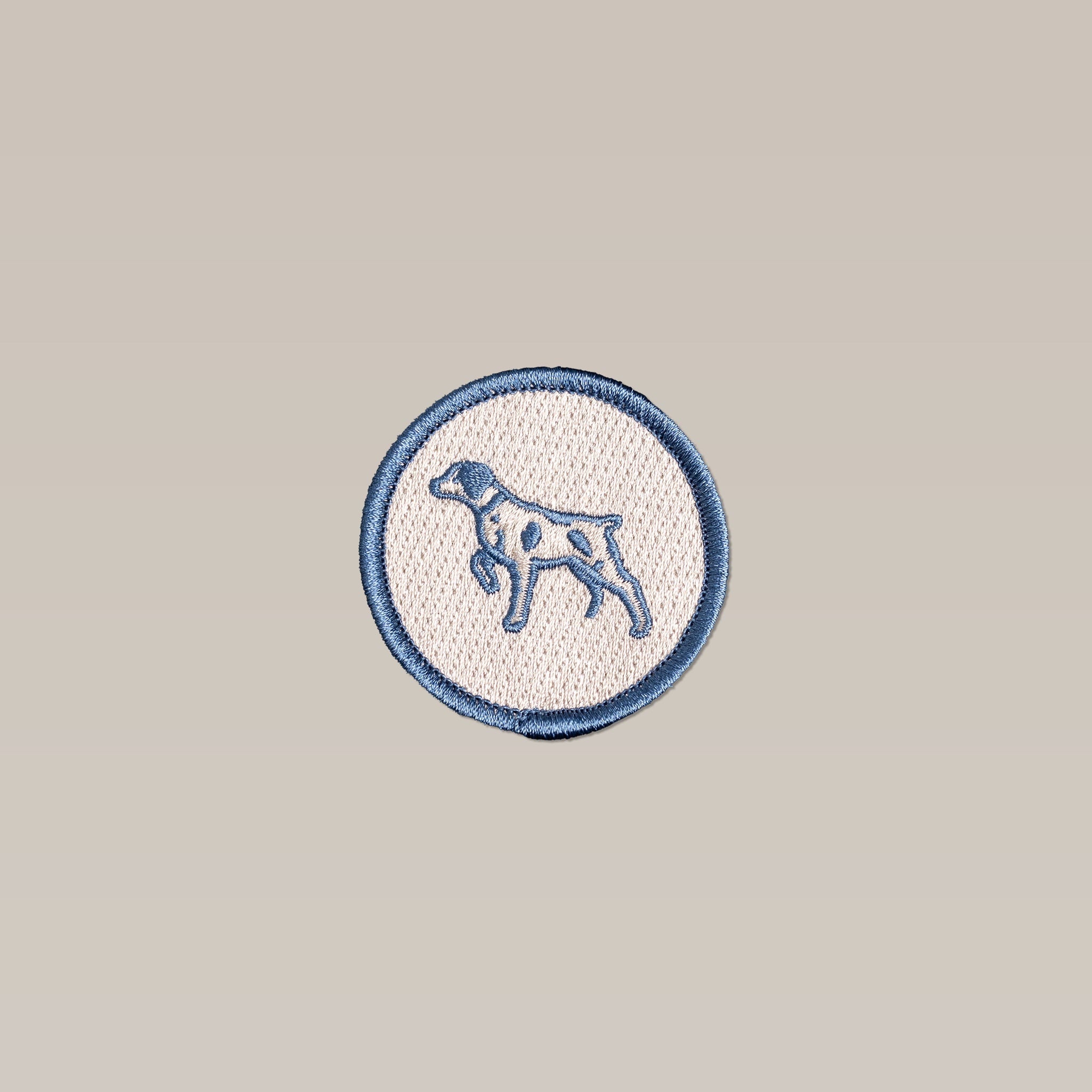 The Ballad of the Bird Dog Shop Patch is a circular embroidered Ballad Merit Badge featuring a blue outline and a standing Bird Dog image—ideal for dog lovers. Brand: Ballad of the Bird Dog.