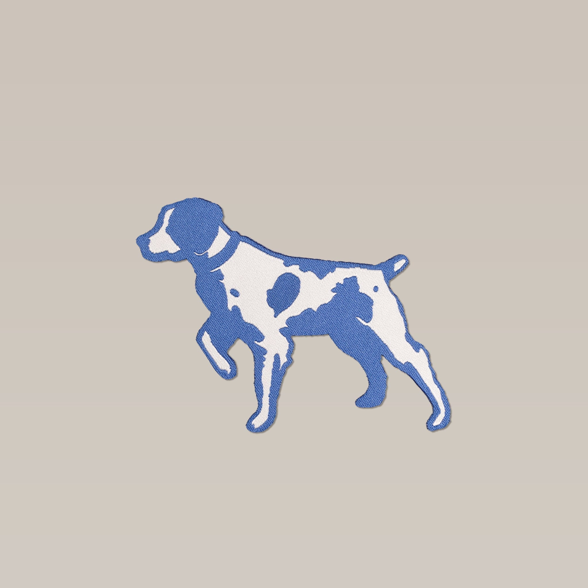 A stylized blue and white illustration of a Pointer with a short tail on light beige, the Shop Patch by Ballad of the Bird Dog is perfect for shop logos or as an eye-catching accessory.