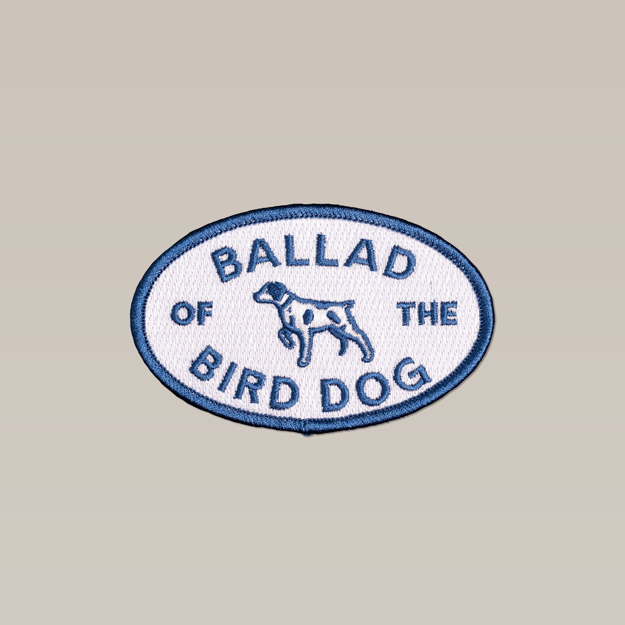 The Shop Patch | Bird Dog Emblem by Ballad of the Bird Dog features an embroidered dog illustration and "BALLAD OF THE BIRD DOG" text on a light background, inspired by the iconic emblem from a local Brenham business.