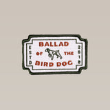 The Ballad of the Bird Dog Shop Patch | Neon Revival features a rectangular embroidered dog logo with "BALLAD OF THE BIRD DOG" and "ESTD 2018" text on a white background, accented by a green border.