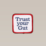 The Shop Patch | Trust Icon by Ballad of the Bird Dog features "Trust your Gut" in blue on white with a red border—a perfect daily intuition patch.