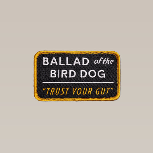 The Ballad of the Bird Dog Shop Patch features "Trust Your Gut" text on a vintage slate background with a yellow border.