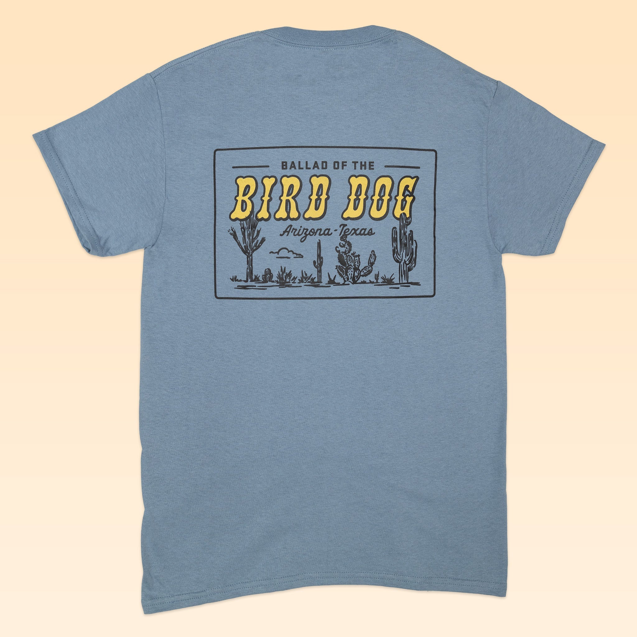 The Shop Shirt | AZ to TX Journey by Ballad of the Bird Dog features a blue design with “Ballad of the Bird Dog Arizona Texas” and desert cacti graphics, perfect for fans of Southwestern style and state pride.