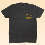 The Ballad of the Bird Dog Shop Shirt | Ballad Flag features vintage black Comfort Colors fabric and yellow "Ballad of the Bird Dog Brenham, TX" text on the left chest—perfect for everyday casual style.