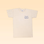 The Ballad of the Bird Dog Shop Shirt features a blue "Ballad of the Bird Dog Brenham, TX" logo on beige organic cotton. Classic Shop Logo Tee is shown laid flat on a light beige background.