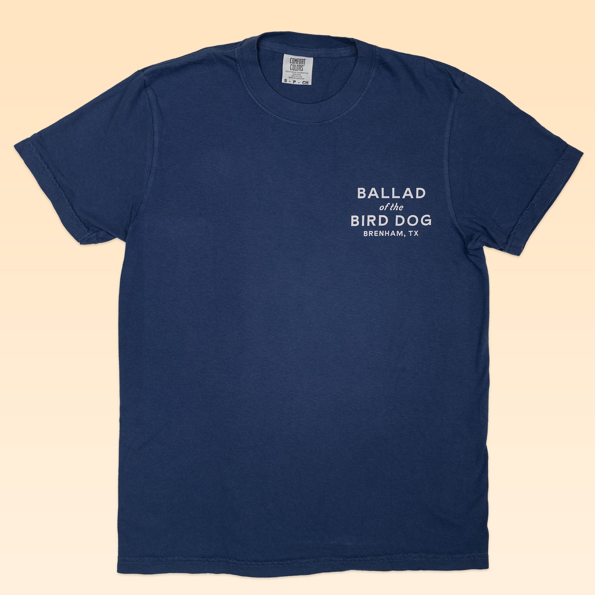 The Ballad of the Bird Dog Shop Shirt features a navy blue Classic Shop Logo Tee with white "BALLAD of the BIRD DOG BRENHAM, TX" text on the upper left chest.
