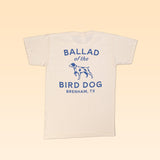 The Ballad of the Bird Dog Shop Shirt features their classic shop logo with a blue dog graphic and "Ballad of the Bird Dog, Brenham, TX" on the back; this cream-colored organic cotton tee is stylish and comfortable.