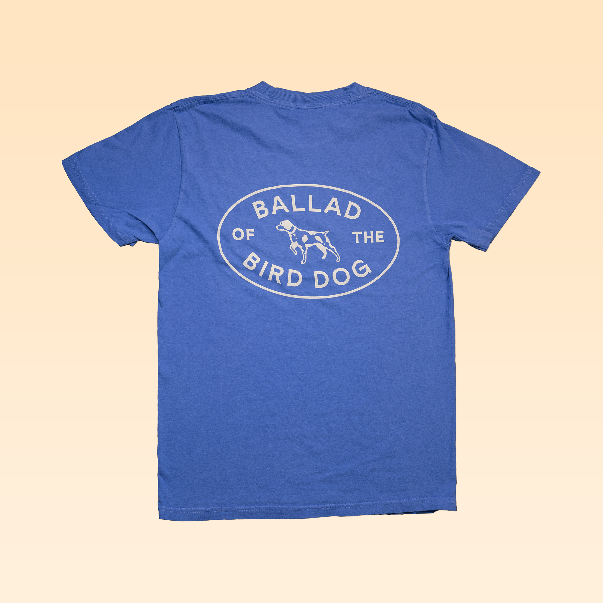 The Shop Shirt | Bird Dog Emblem by Ballad of the Bird Dog features an oval "Ballad of the Bird Dog" logo and a dog illustration—perfect for showing your bird dog pride inspired by Downtown Brenham.