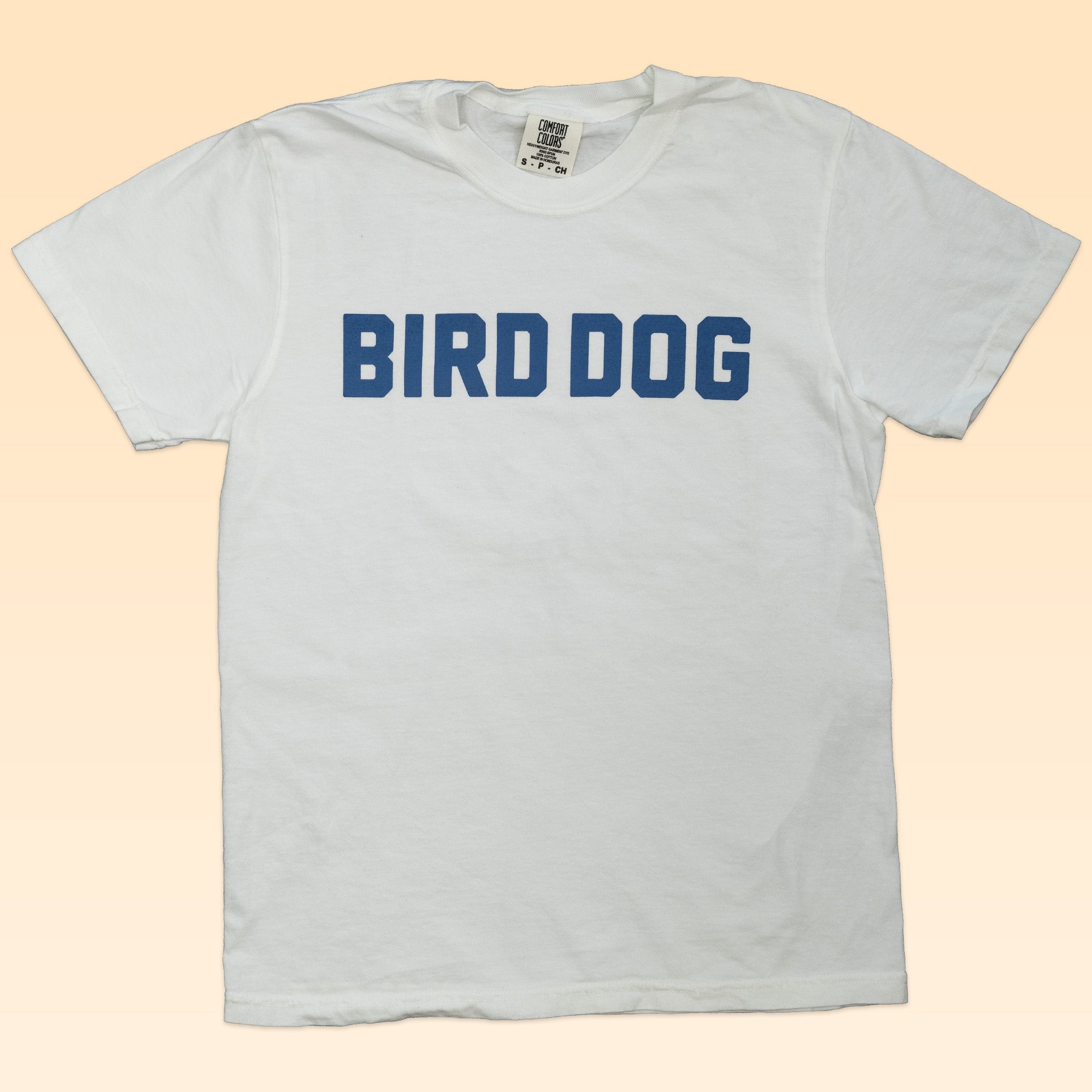 The Shop Shirt | Bird Dog Honor by Ballad of the Bird Dog features bold blue "BIRD DOG" lettering—ideal for fans of classic hunting dog style.