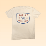 The Ballad of the Bird Dog “Shop Shirt | Bird Dog Legend” features a white design with a large badge-style back graphic of a dog and “Ballad Of The Bird Dog”—ideal for fans of classic hunting shirts.