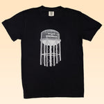 Show your Brenham pride with the Shop Shirt by Ballad of the Bird Dog—a black tee featuring a white "Welcome to Brenham" water tank graphic. Perfect for fans of the iconic Brenham Water Tank.
