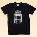 Show your Brenham pride with the Shop Shirt by Ballad of the Bird Dog—a black tee featuring a white "Welcome to Brenham" water tank graphic. Perfect for fans of the iconic Brenham Water Tank.