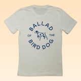 The Shop Shirt | Circle Clubhouse Tradition by Ballad of the Bird Dog features a dog graphic with "BALLAD OF THE BIRD DOG" in blue—perfect for fans of circle logo tees.