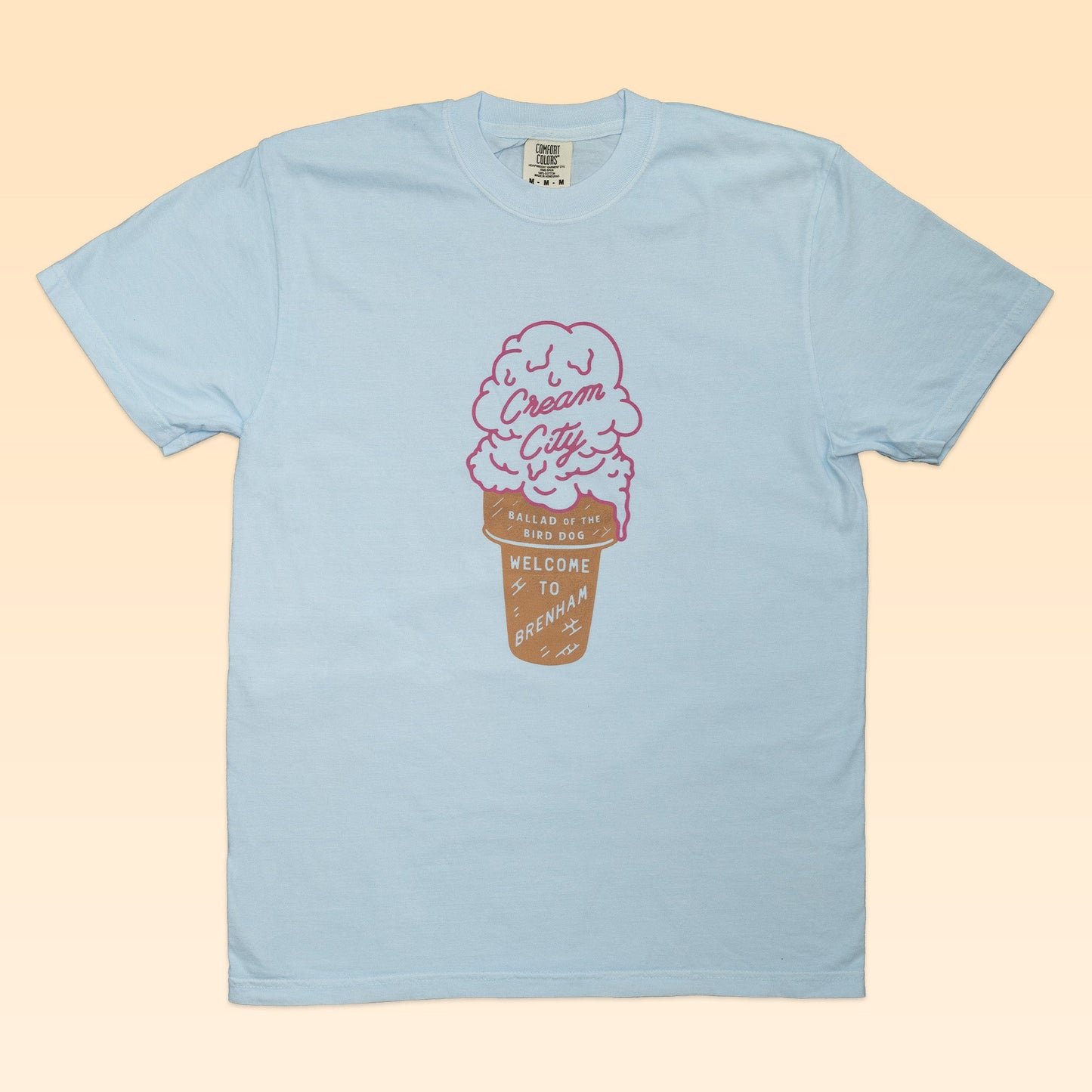 Light blue Ballad of the Bird Dog Shop Shirt | Cream City features a pink ice cream cone graphic inspired by Blue Bell, with "Cream City" and "Welcome to a brand new day"—a sweet tribute to Brenham charm.