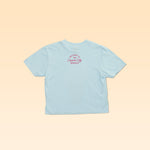 The Ballad of the Bird Dog Shop Shirt | Cream City Crop is a light blue short-sleeve tee, laid flat to show "Welcome to the Cream City Brewing" in red near the back collar.