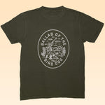 Ballad of the Bird Dog’s Shop Shirt | Desert Covey Flush is an olive green tee featuring a hand-printed white graphic on the back with a desert scene and "Ballad of the Bird Dog"—ideal outdoor apparel for adventure lovers.