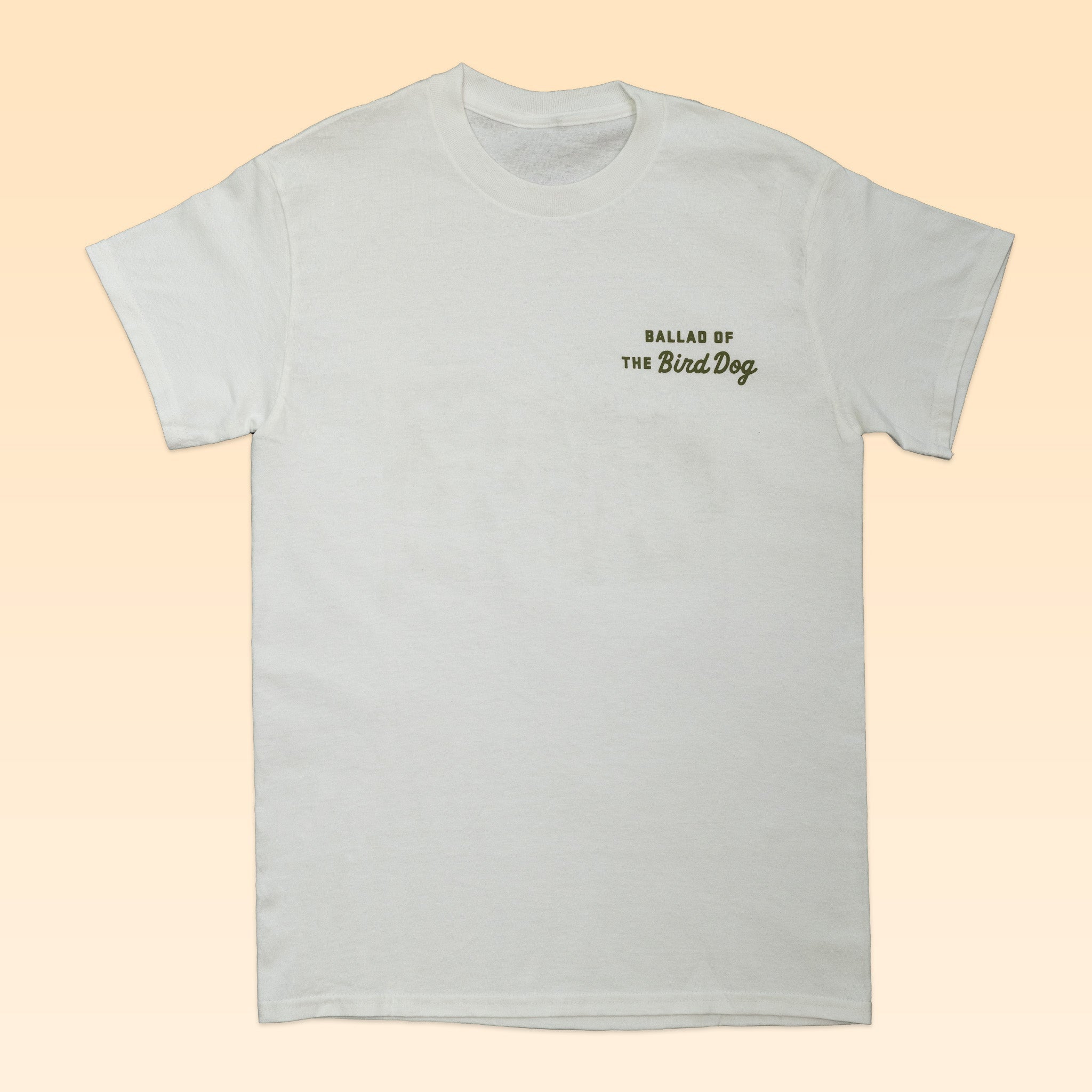 The Shop Shirt | Desert Hunt by Ballad of the Bird Dog is a white tee with black and green "BALLAD OF THE Bird Dog" text on the chest—ideal for outdoor dog lovers seeking adventure.