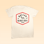 The Shop Shirt | Field Companion by Ballad of the Bird Dog features a hexagonal back logo reading "Ballad of the Bird Dog Texas" and an original dog illustration, reflecting the brand's legacy.