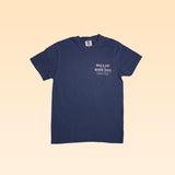 The Shop Shirt | General Goods by Ballad of the Bird Dog is a navy blue tee with "BALLAD BIRD DOG GENERAL GOODS" in white on the left chest, inspired by classic general goods stores, shown on a light beige background.