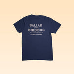 The Shop Shirt from Ballad of the Bird Dog is a navy tee with "BALLAD OF THE BIRD DOG, 100 S ALAMO ST, BRENHAM, TX, GENERAL GOODS" in white—a tribute to the beloved general goods store in Downtown Brenham.
