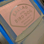 A screen printing frame with a "BALLAD of the BIRD DOG, 100 E ALAMO ST, BRENHAM, TX" stencil and gray ink, made for the Shop Shirt | Home Base by Ballad of the Bird Dog.