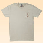 The Shop Shirt by Ballad of the Bird Dog (Horny Toad) features a beige design with a small circular plant graphic and text on the left chest. Part of the Desert Scenes Collection, its label reads “Ballad Bird Dog.”.