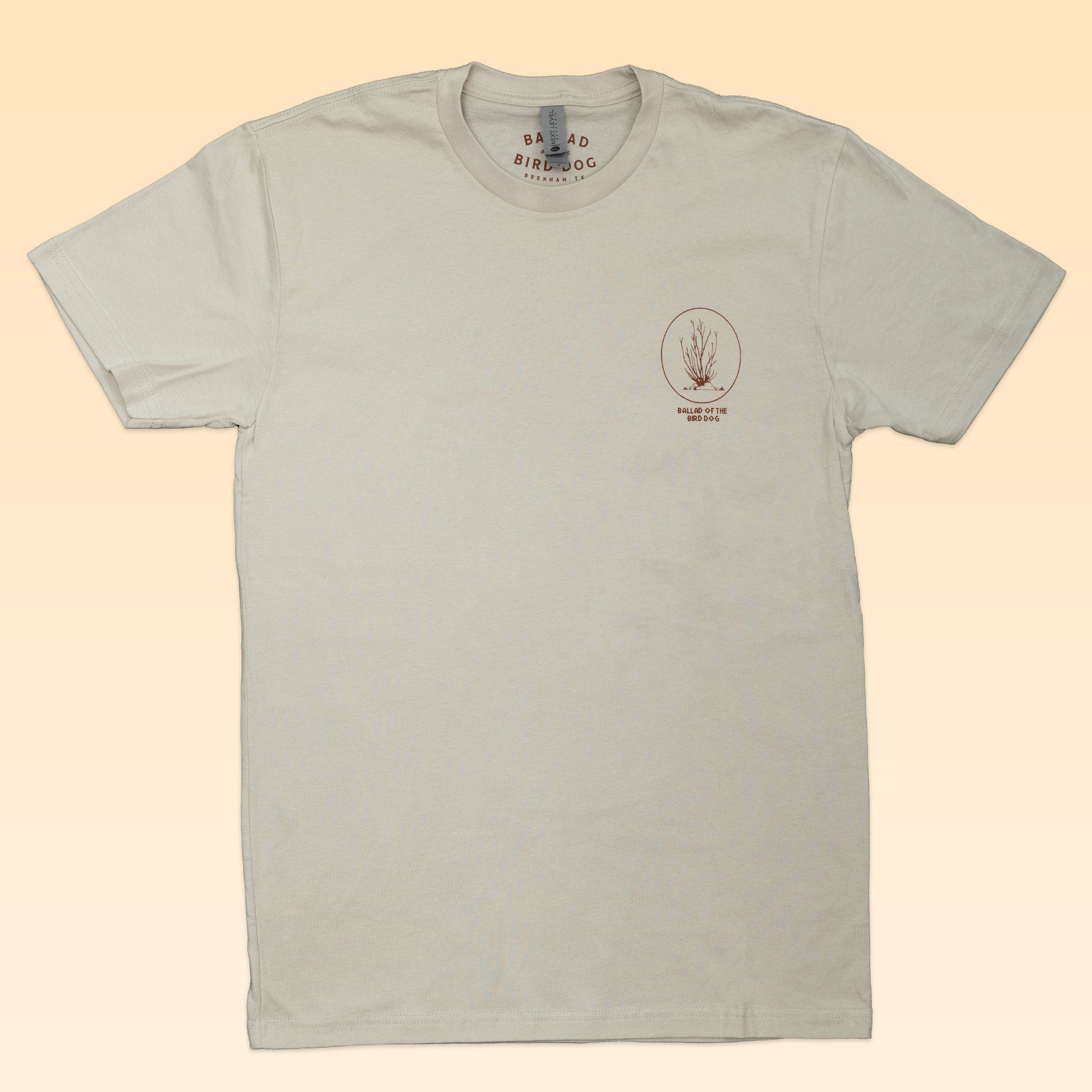 The Shop Shirt | Horny Toad by Ballad of the Bird Dog is a beige short-sleeve tee with a small brown botanical illustration and text on the left chest, part of Ballad of the Bird Dog’s “Desert Scenes Collection.”.