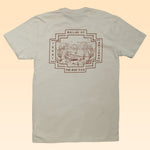 The back of the beige Shop Shirt | Horny Toad | Ballad of the Bird Dog from Ballad of the Bird Dog features a desert landscape graphic and the text “Ballad of Texas Arizona The Bird Dog.” Part of our Desert Scenes Collection.