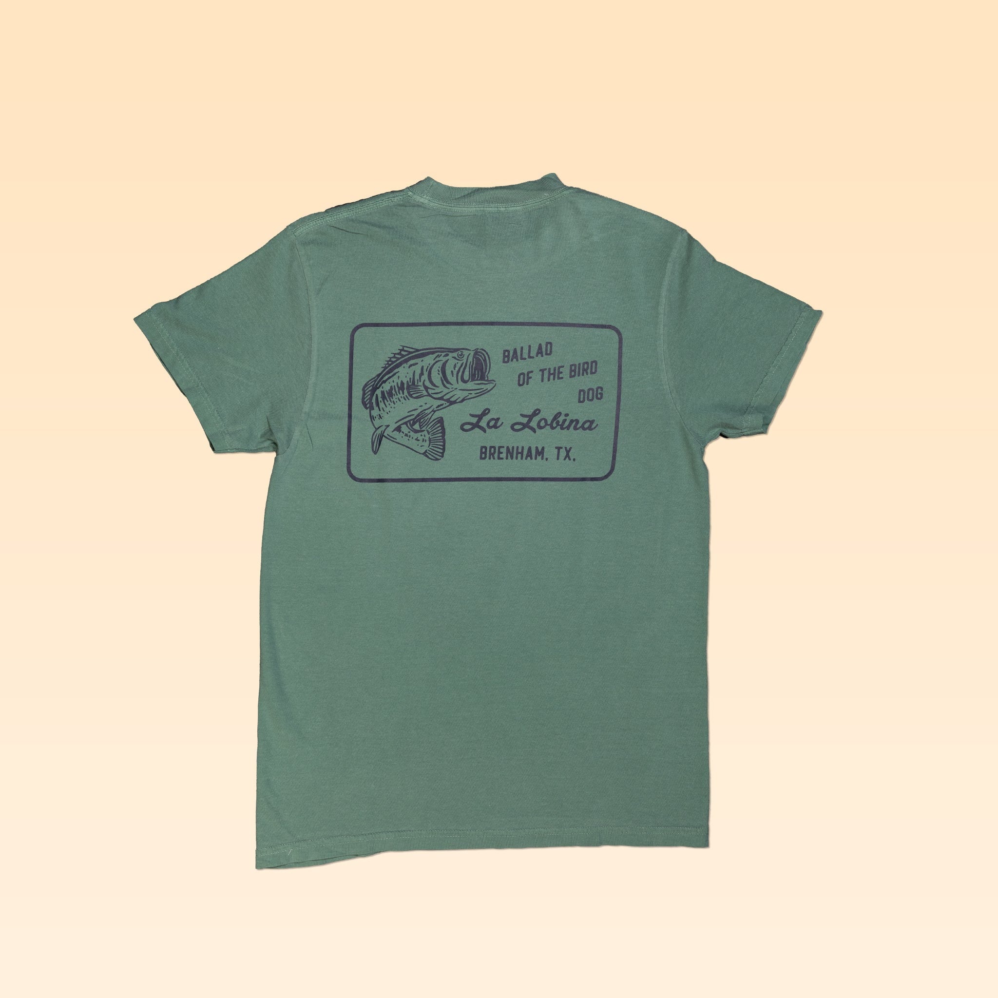 The Shop Shirt | La Lobina by Ballad of the Bird Dog features a black line fish drawing and “BALLAD OF THE BIRD DOG La Lobina BRENHAM, TX” on the back—ideal angler apparel for your next outdoor adventure.