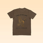 The Ballad of the Bird Dog "Shop Shirt | Loyal to The Land" is a brown tee featuring a quail graphic with "LOYAL TO THE LAND" above and "BALLAD OF THE BIRD DOG" below the bird on the back.