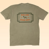 The Ballad of the Bird Dog Shop Shirt | Neon Revival is a khaki tee with a rectangular back graphic featuring a dog illustration and "Ballad of the Bird Dog" text, giving off retro logo shirt vibes for fans of nostalgic style.
