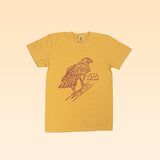 The Shop Shirt by Ballad of the Bird Dog features a yellow, soft USA cotton tee with a Red-Tailed Hawk line drawing and “DALLAS BIRD DOG” on the front. Part of the Desert Scenes Collection Red-Tailed Hawk series.