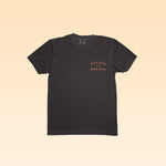 The Shop Shirt | Retriever by Ballad of the Bird Dog is a plain black tee featuring "Ballad of the Bird Dog" in small orange letters on the left chest.