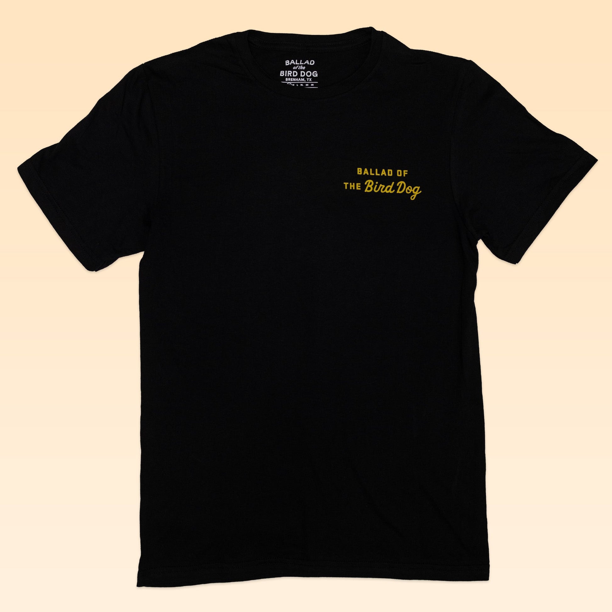 The Shop Shirt | Scorpion by Ballad of the Bird Dog is a black tee from their Desert Scenes Collection, featuring small yellow “BALLAD OF THE Bird Dog” text hand-printed on the upper left chest for a unique look.
