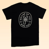 The Shop Shirt | Scorpion by Ballad of the Bird Dog features a white oval scorpion design and text on the back—a unique hand-printed tee from our Desert Scenes Collection.