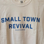 The Ballad of the Bird Dog Shop Shirt | Small Town Revival Crop is a handcrafted beige cotton shirt with blue "SMALL TOWN REVIVAL" text above “BALLAD OF THE BIRD DOG”—celebrating small town community pride.