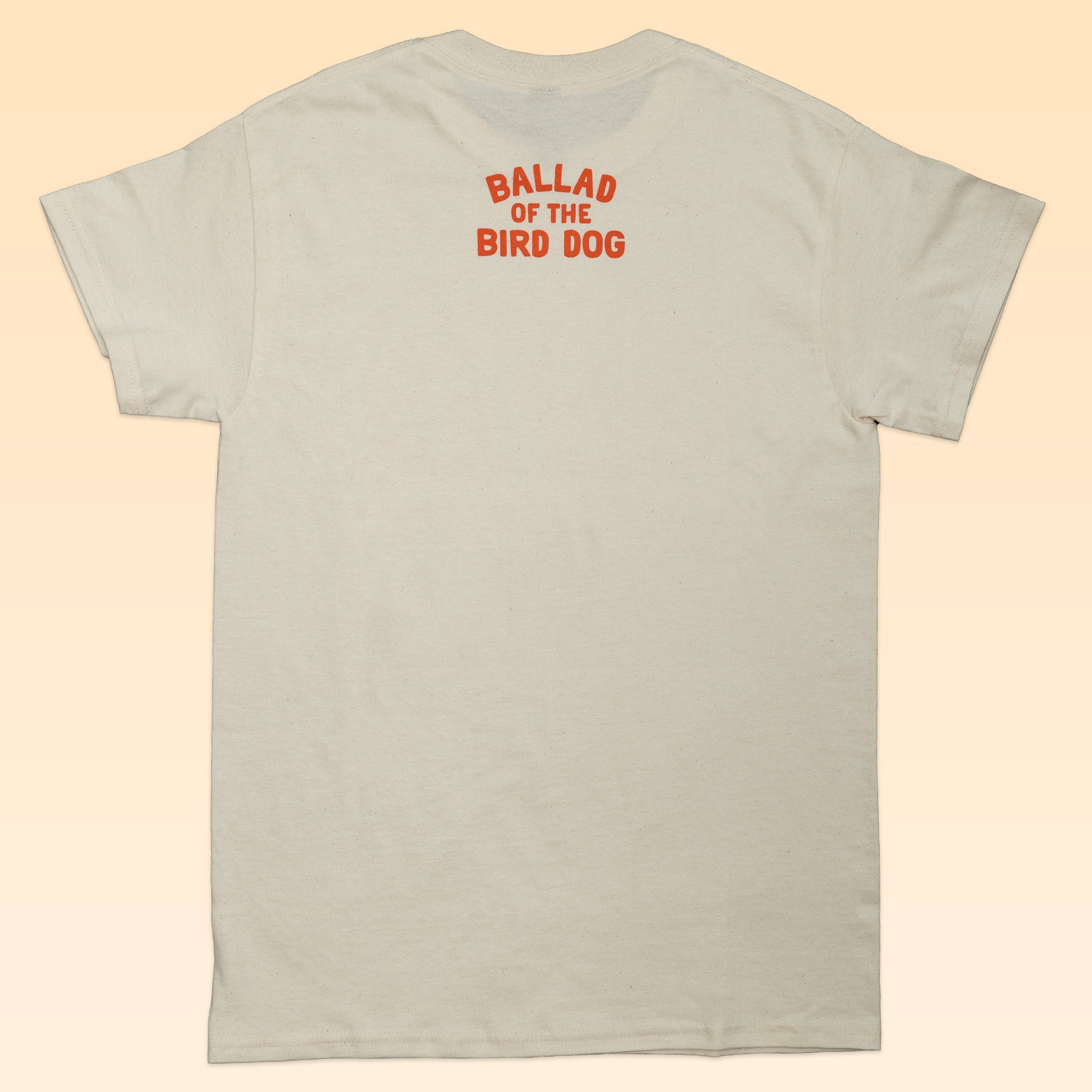 Beige Shop Shirt by Ballad of the Bird Dog, featuring "BALLAD OF THE BIRD DOG" in red on the upper back—a tribute to small town Texas charm.