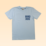 The Ballad of the Bird Dog Shop Shirt | Team Bird Dog features "BIRD DOG" in bold blue on light blue, laid flat on beige—ideal for fans of classic baseball jersey style bird dog apparel.