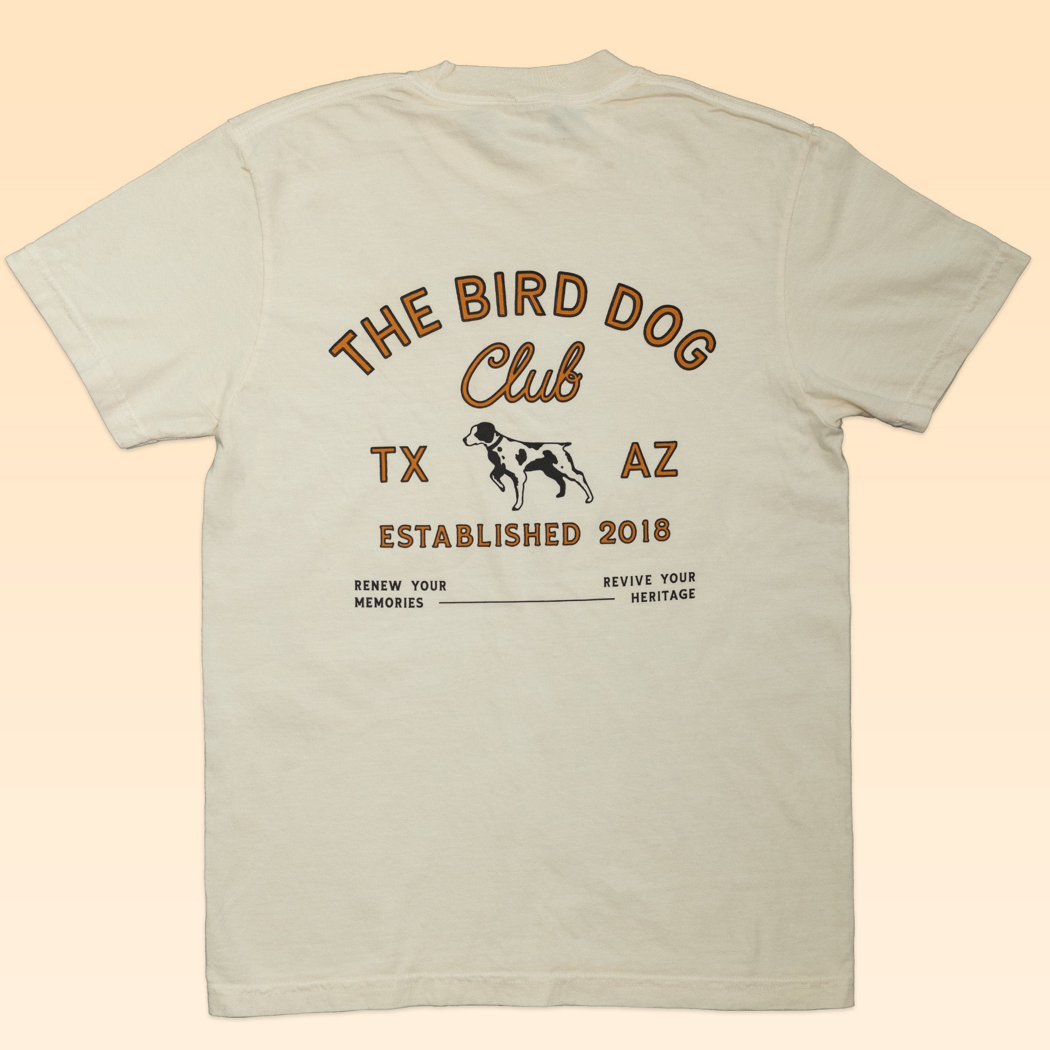 The Ballad of the Bird Dog “Shop Shirt | The Bird Dog Club” is a cream tee with "The Bird Dog Club" text, dog graphic, "TX AZ," "Established 2018," and the phrases "Renew Your Memories" and "Revive Your Heritage”—ideal for outdoor enthusiasts.