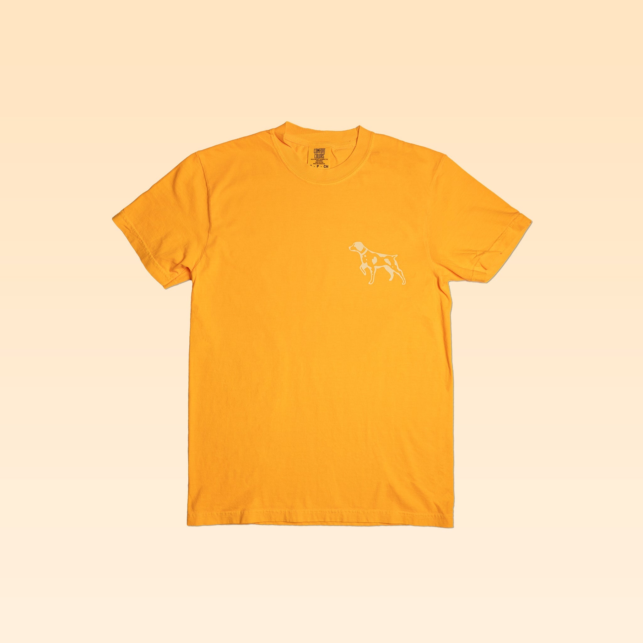 The Shop Shirt | Upland by Ballad of the Bird Dog is a plain yellow tee with a small white outline graphic of a dog on the left chest, shown on a light yellow background.