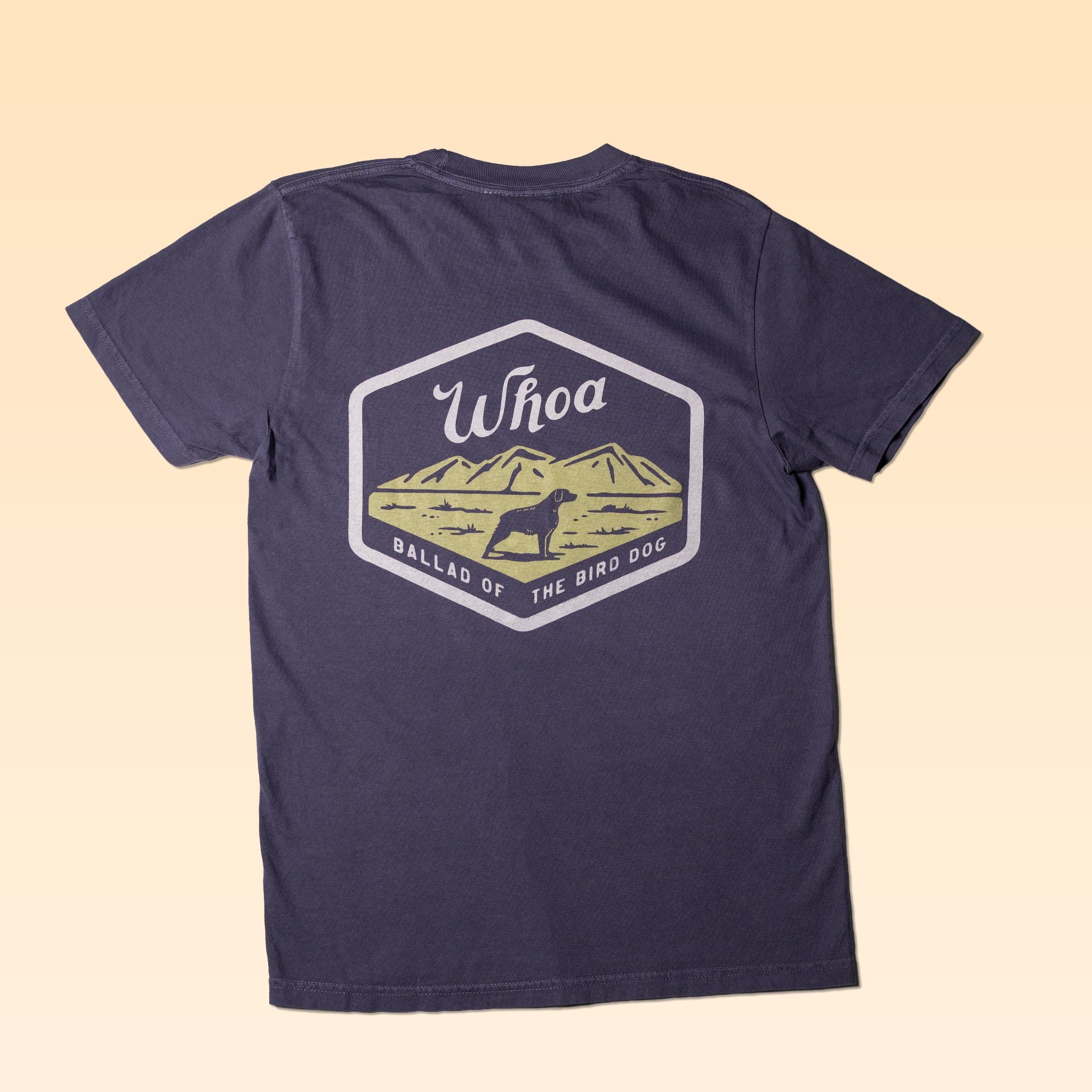 The Ballad of the Bird Dog "Shop Shirt | Whoa" features a dark tee with a back graphic of a dog before mountains, the word “Whoa,” and “Ballad of the Bird Dog” text.