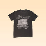 The 1844 Liquor Market Shop Shirt features a white line drawing of a two-story building and "1844 Liquor Market" text on the front, with "Winner Winner Chicken Dinner" printed on the back—a vintage-style black tee from 1844 Liquor Market.