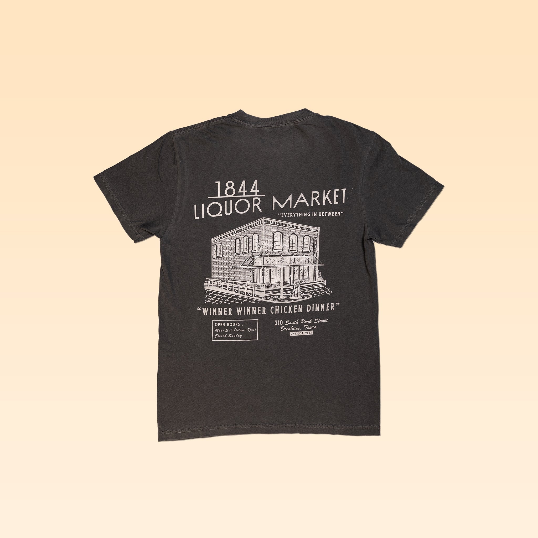 The 1844 Liquor Market Shop Shirt features a white line drawing of a two-story building and "1844 Liquor Market" text on the front, with "Winner Winner Chicken Dinner" printed on the back—a vintage-style black tee from 1844 Liquor Market.