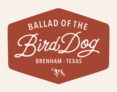 The Ballad of the Bird Dog Shop Sticker features a hexagonal red Bird Dog Badge with white text and a dog outline, perfect for celebrating hunting heritage.