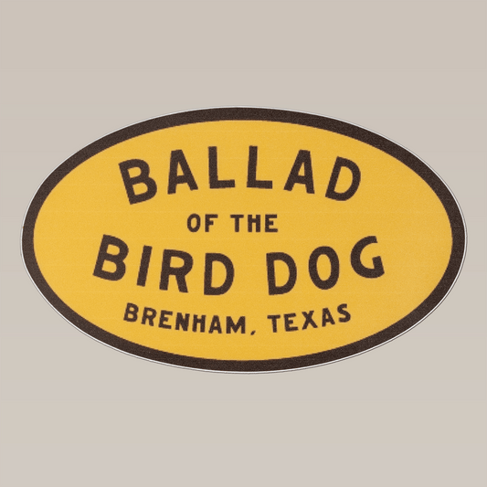 The Shop Sticker | Classic Oval by Ballad of the Bird Dog is a 5-inch yellow oval sticker featuring "Ballad of the Bird Dog, Brenham, Texas" in black text—ideal as a cooler decal.