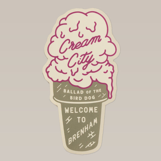 Shop Sticker | Cream City by Ballad of the Bird Dog features an ice cream cone design with "Cream City," "Ballad of the Bird Dog," and "Welcome to Brenham" on a beige background—a playful tribute to Brenham, home of Blue Bell Creameries.