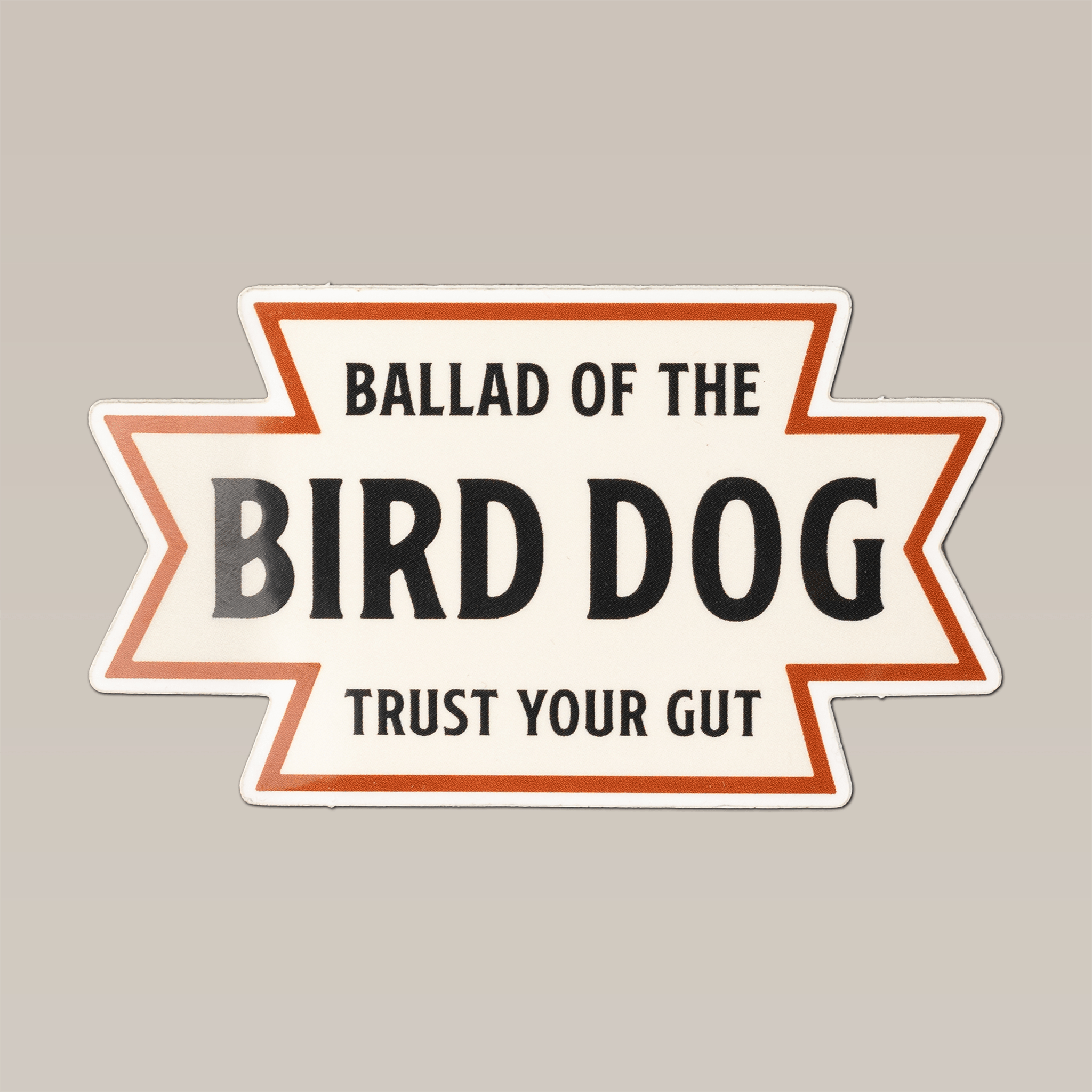 The Ballad of the Bird Dog "Desert Dog" Shop Sticker features "Trust Your Gut" in black and orange on a beige background, capturing a Southwestern, American desert-inspired design.