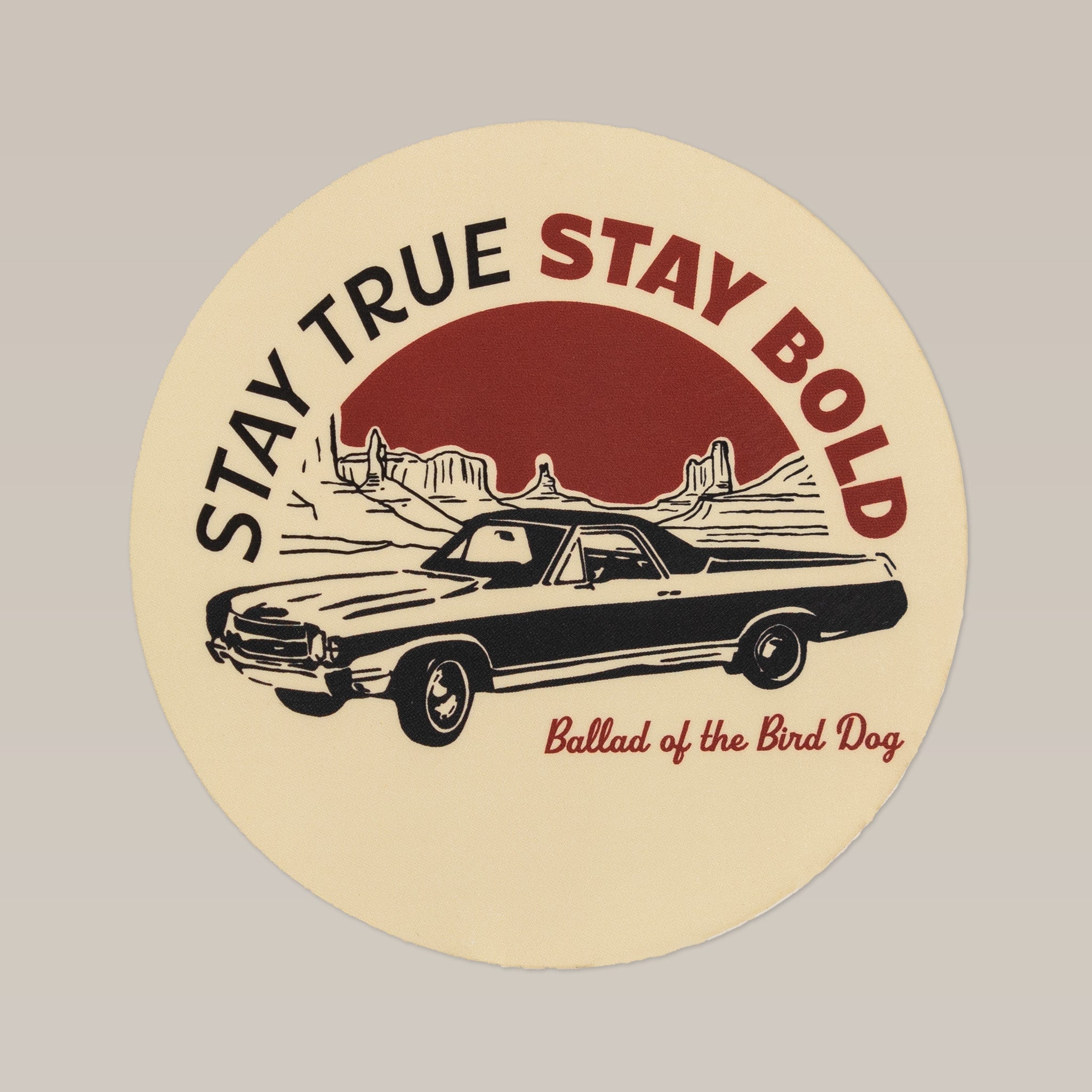 The Shop Sticker | El Camino by Ballad of the Bird Dog is a round sticker featuring a vintage car with mountains and the phrases "STAY TRUE STAY BOLD" and "Ballad of the Bird Dog.