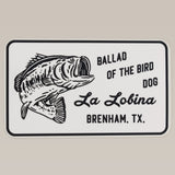 Shop Sticker | La Lobina by Ballad of the Bird Dog features a black and white largemouth bass and "La Lobina Brenham, TX" text—ideal for fishing sticker enthusiasts and bass anglers.